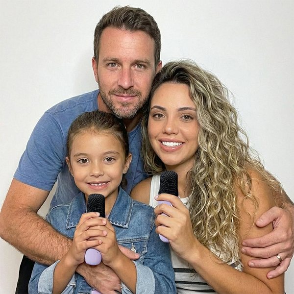 Family holding IROO karaoke microphones
